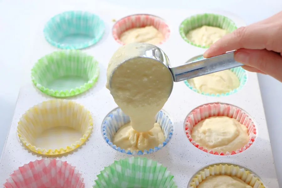 clickbizhub adding cupcake mix to the pan